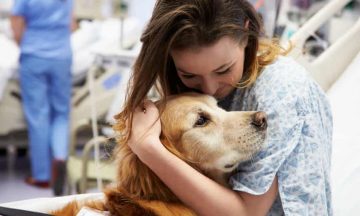 A woman holding a dog