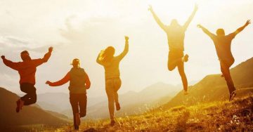 A group of people standing on top of a hill